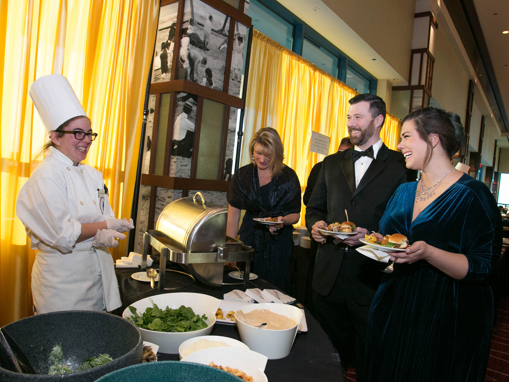 culinary student serving guests at gala